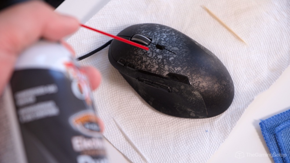 Canned air blowing out debris from gaming mouse